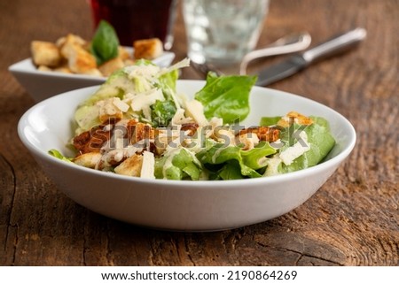 caesar salad on dark wood