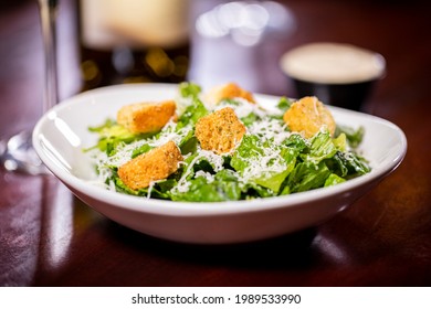 Caesar Side Salad With Green Romaine Lettuce Croutons Shredded Parmesan Cheese In Small White Bowl