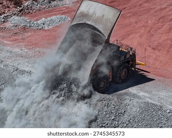 CAEX mining truck in the process of dumping mine waste material at the landfill