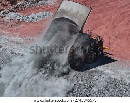 CAEX mining truck in the process of dumping mine waste material at the landfill
