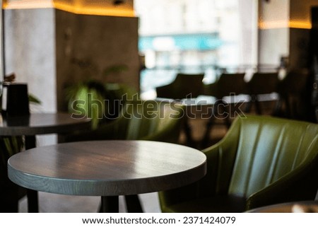 cafe bar restaurant nobody indoor. Empty coffee shop interior daytime with big window, green chairs and decorative lighting. 