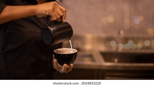 Cafe barista showing decoration  milk cream on top of coffee before serve to customer who order at cafe restaurant . - Powered by Shutterstock