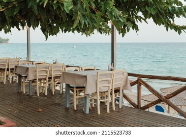 Cafe With Empty Tables Near The Sea. Open Air Restaraunt Near Sea. Greek Tavern.