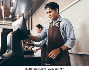 Cafe handsome Asia man waitress cashes in order bill register working happy at coffee shop - Powered by Shutterstock