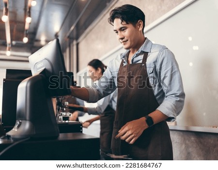Cafe handsome Asia man waitress cashes in order bill register working happy at coffee shop