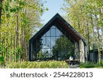 Cafe in the middle of forest with a lot of trees in the background. Green eco nature cafe concept.