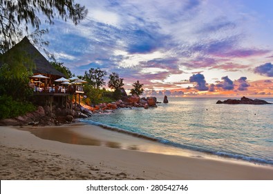 Cafe on Seychelles tropical beach at sunset - nature background