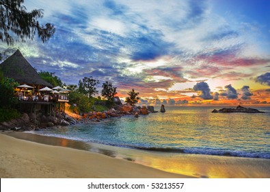 Cafe on tropical beach at sunset - nature background