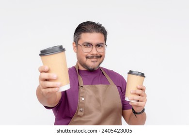 A cafe owner or manager presenting two cups of coffee. Wearing a purple waffle shirt and a brown apron. Isolated on white background.
