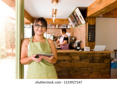 Cafe owner posing at camera.