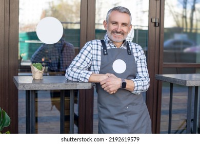 Cafe Owner Standing Near The Table Outside And Looking Happy