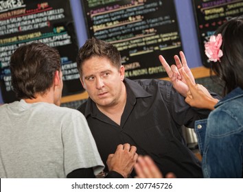 Cafe Owner Talking With Rude Customers In Line