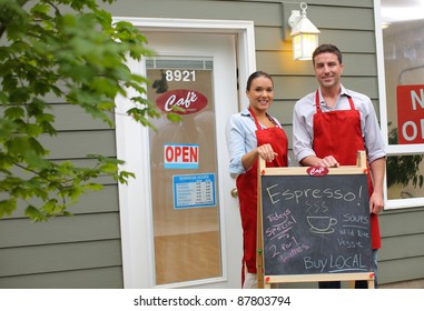 Cafe owners in front of shop - Powered by Shutterstock