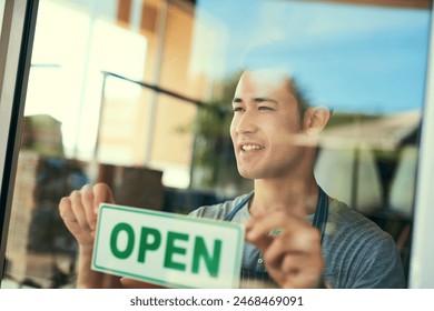 Cafe, startup and man with open sign for coffee shop, restaurant or deli in city. Male entrepreneur, store and opening for trade for small business, window and owner with signage for service industry - Powered by Shutterstock