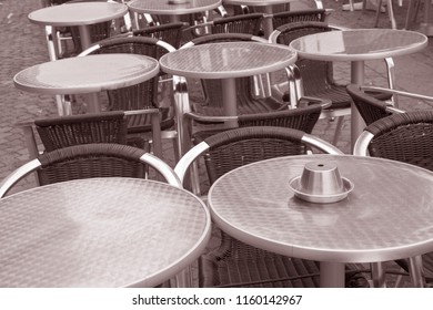 Cafe Table And Chairs In Malmo, Sweden In Black And White Sepia Tone