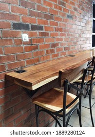 A cafe table in one of the coffee shops. Made of teak wood, coated with melamine. 