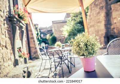 Cafe With Tables And Chairs In An Old Street In Europe With Retro Vintage Instagram Style Filter Effect