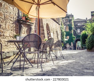 Cafe With Tables And Chairs In An Old Street In Europe With Retro Vintage Instagram Style Filter Effect