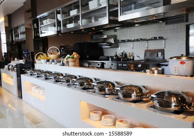 The Cafeteria Buffet And Kitchen With A Lot Of Various Steel Utensils