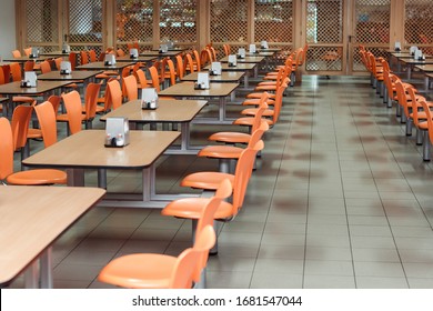 Cafeteria or canteen interior. School cafeteria. Factory canteen with chairs and tables, nobody. Modern cafeteria interior. Clean canteen in modern school. Lunch room.