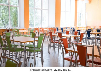 Cafeteria or canteen interior. School cafeteria. Factory canteen with chairs and tables, nobody. Modern cafeteria interior. Clean canteen in modern school. Lunch room. - Shutterstock ID 2265258341