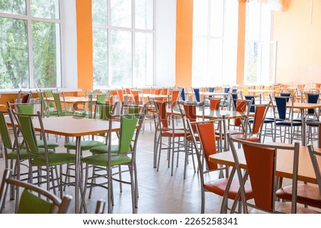 Cafeteria or canteen interior. School cafeteria. Factory canteen with chairs and tables, nobody. Modern cafeteria interior. Clean canteen in modern school. Lunch room.