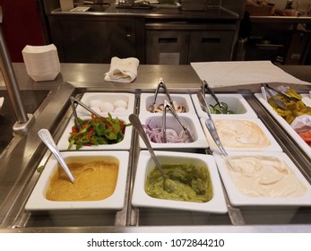 Cafeteria Station With Sandwich Toppings And Condiments Like Eggs, Avocado, Onions, Green Peppers