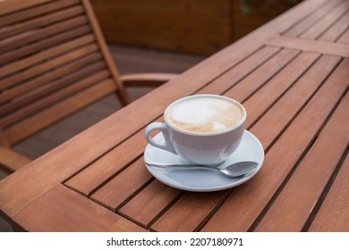 Caffe Latte. Cup of coffee with a sweet cookie. Good morning drink. Rustic wooden background. Close up.Breakfast coffee, Cappuccino art on vintage wooden table - Shutterstock ID 2207180971