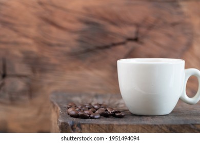 Caffee Cup And Coffee Beans On A Rustic Wooden Background