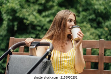 Caffeine And Breastfeeding. Young Mom With Coffee To Go Cup Walk With Newborn Son. Mother Walk With Newborn Baby In Stroller While Drinking Take Away Coffee.