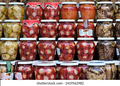 Cagliari / Italiy - June 7 2019: Wall Of Glass Jars With Picked Vegetables From Calabria At The Street Food Festival