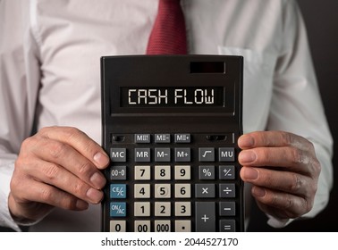 Cah Flow Words On Calculator In Hands. Cashflow Concept.