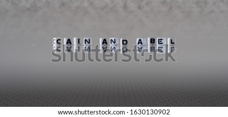 cain and abel concept represented by wooden letter tiles