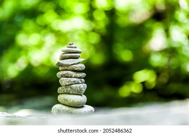 Cairn in forest against blurred green background - Powered by Shutterstock