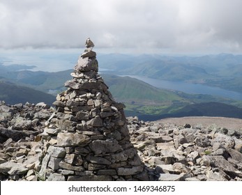 Cairn on summit peak with spiritual mountain view
