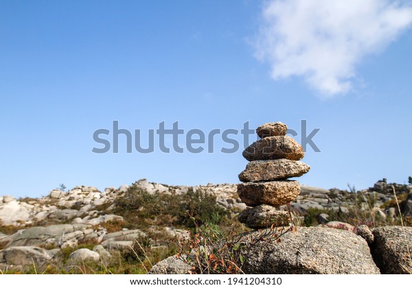 Cairn or stone marker\
in mountain trail 