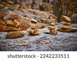 Cairn stone stacks in a rock surrounded by Maine rocky coasts