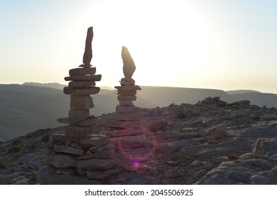 Cairn At Sunrise, Stones Balances, Pyramid Of Stones At Sunset, Concept Of Life Balance, Harmony And Meditation. A Pile Of Stones In Desert Mountains, Crater Ramon, Israel