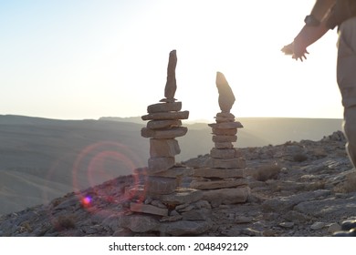 Cairn At Sunrise, Stones Balances, Pyramid Of Stones At Sunset, Concept Of Life Balance, Harmony And Meditation. A Pile Of Stones In Desert Mountains, Crater Ramon, Israel