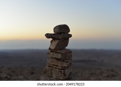 Cairn At Sunrise, Stones Balances, Pyramid Of Stones At Sunset, Concept Of Life Balance, Harmony And Meditation. A Pile Of Stones In Desert Mountains, Crater Ramon, Israel