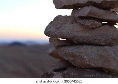 Cairn At Sunrise, Stones Balances, Pyramid Of Stones At Sunset, Concept Of Life Balance, Harmony And Meditation. A Pile Of Stones In Desert Mountains, Crater Ramon, Israel