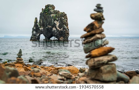 Cairns on the beach with Hvítserkur in the background, Iceland