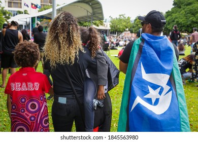 CAIRNS, QLD, Australia - JUNE 7th, 2020: An Indigenous Family Stand In A Crowd During A Black Lives Matter Protest, One Man Wears A Torres Strait Islander Flag Over His Shoulders