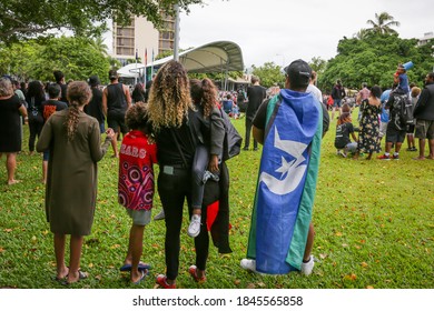 CAIRNS, QLD, Australia - JUNE 7th, 2020: An Indigenous Family Stand In A Crowd During A Black Lives Matter Protest, One Man Wears A Torres Strait Islander Flag Over His Shoulders