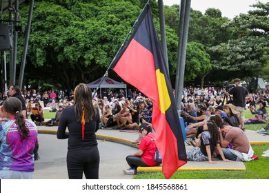 CAIRNS, QLD, Australia - JUNE 7th, 2020: A Woman Holds A Large Indigenous Aboriginal Australian Flag During A Black Lives Matter Protest