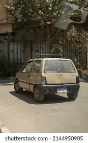 Cairo, Egypt, 20 June 2021: Old Classic Gold Hatchback With Damaged Lights Parked At Street On Sunny Day