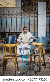 CAIRO, EGYPT - April 2018: Egyptian men smoking shisha (hookah) at street tea shop at Old Cairo district, Egypt