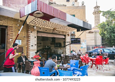 CAIRO, EGYPT - April 2018: Egyptian men smoking shisha (hookah) at street tea shop at Old Cairo district, Egypt