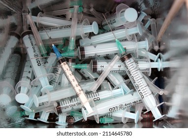 Cairo, Egypt, January 15 2022: selective focus of a closeup of medical waste of sharp needles, syringes inside a safety box, dangerous sharp used objects inside a disposable bin
