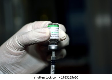 Cairo, Egypt, May 30, 2021. A medical personnel holds Sinopharm COVID-19 vaccine bottle dose loaded in a syringe , Sars-Cov-2 Vaccine inactivated vero cell, Sinopharm is a Chinese state-owned company